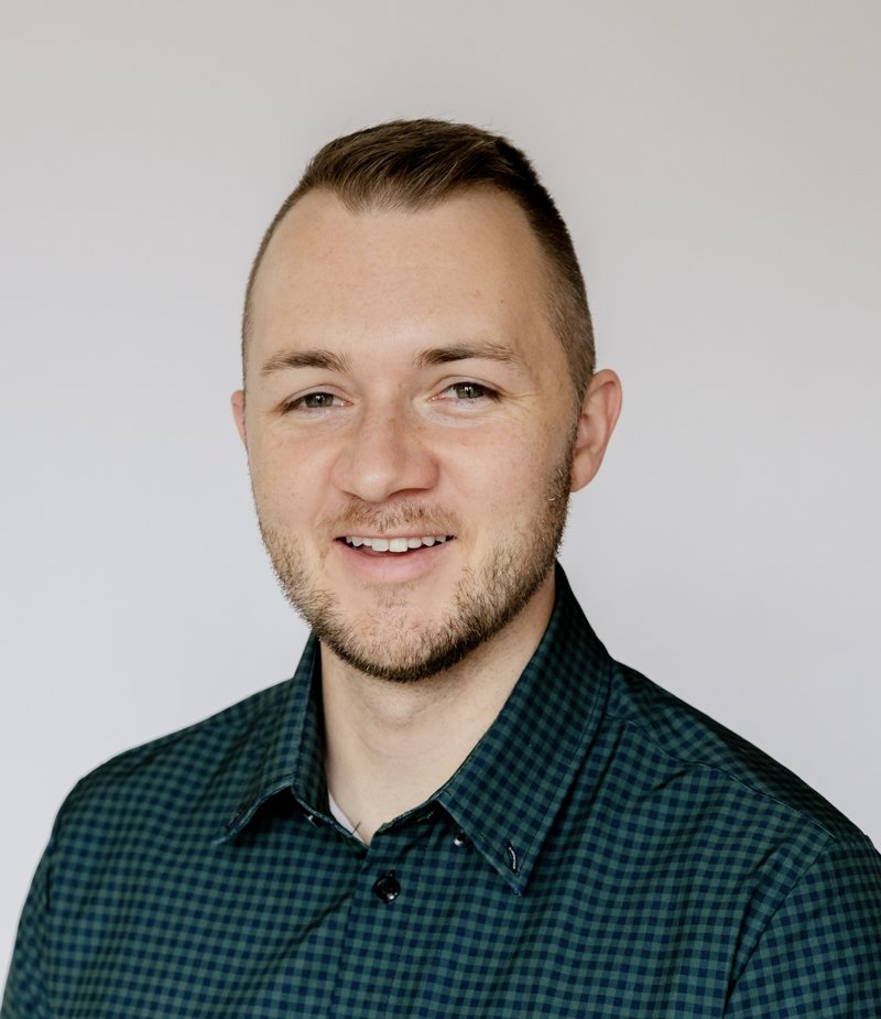Corbin Hatch, PMHNP-BC, smiling in a green checked shirt